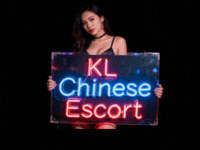Woman holding a sign that says "KL Chinese Escort